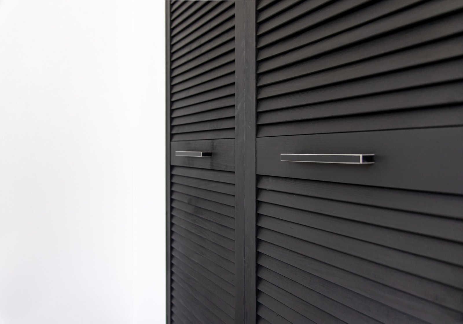 Close up of a textured wooden black cabinet.
