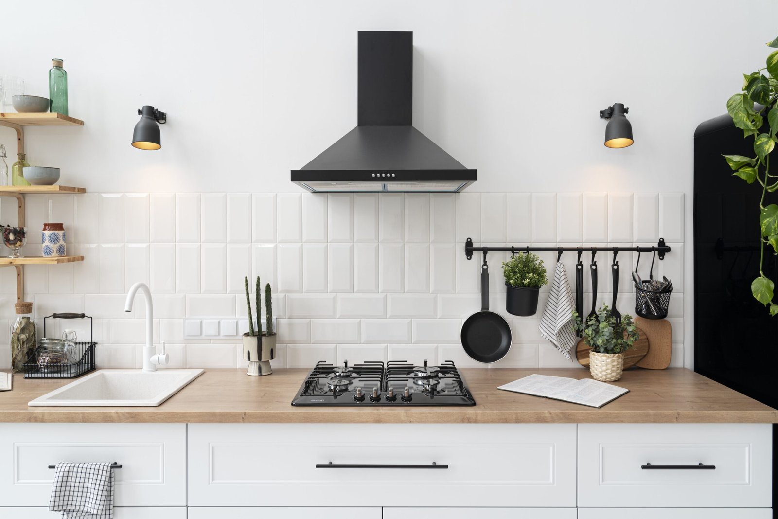 kitchen design with white wall white cabinets and black heat execavater