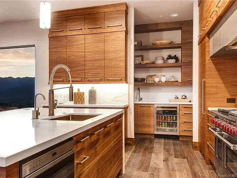 Contemporary kitchen with wooden cabinets, modern fixtures, and sleek countertops
