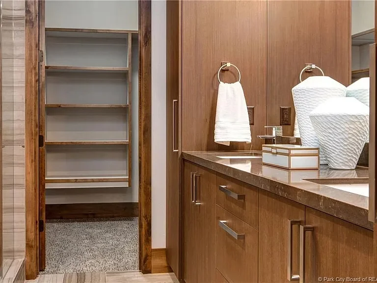 A modern bathroom featuring a walk-in shower and a sleek sink, designed for functionality and style.