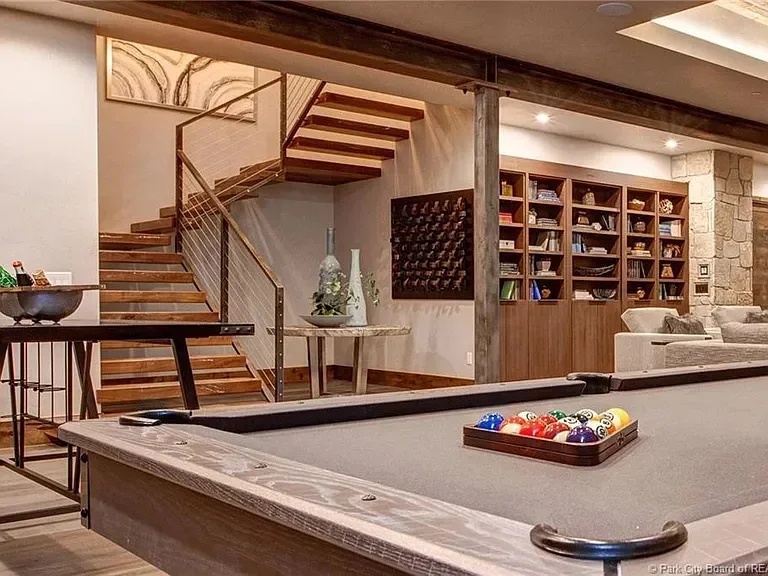 Home interior with pool table and stylish bar, creating a fun entertainment space.